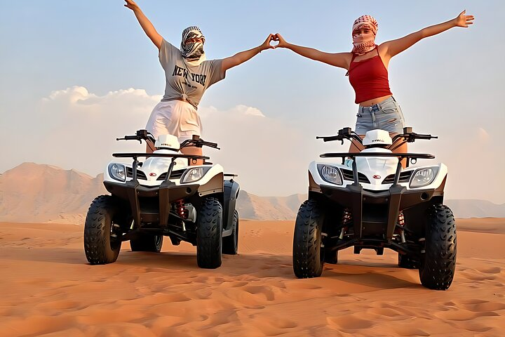 Experience the beauty of Dubai's desert landscape as you navigate the historic Fossil Rocks of Sharjah discovering unique sculptures amidst sandy dunes on an adventurous quad bike tour.